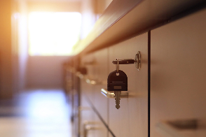 keys are resting in the lock of a locking cabinet.