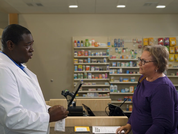 A pharmacist talking to a women - screen capture from the training video.