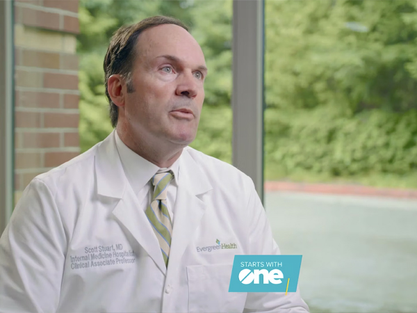 A doctor sitting and giving an interview.